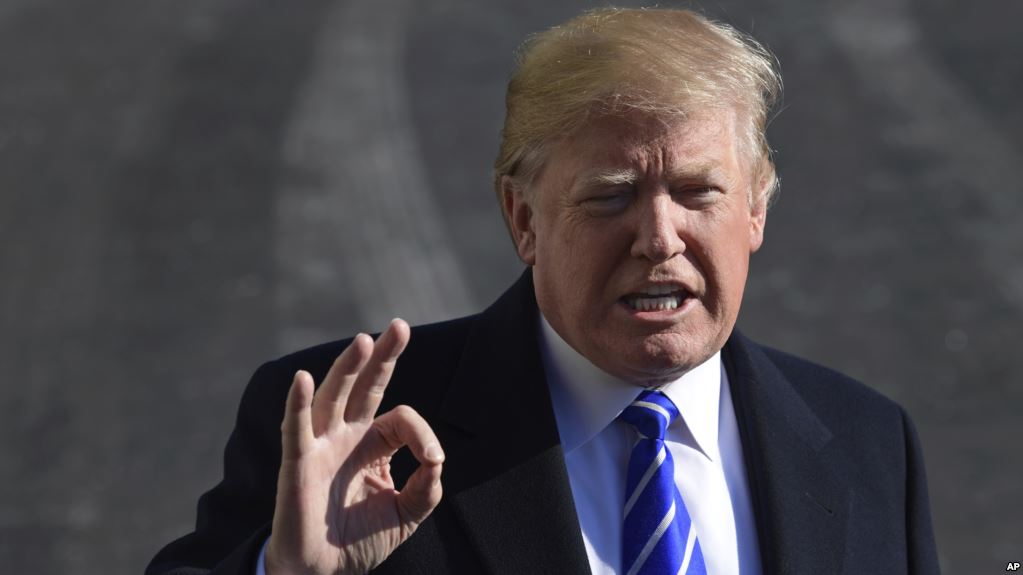 President Donald Trump talks with reporters as he departs from the South Lawn of the White House via Marine One in Washington, Saturday, Dec. 16, 2017, to spend the weekend at Camp David in Maryland. (AP Photo/Susan Walsh)